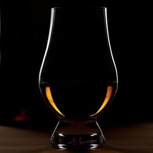 whisky in a glass with dark background