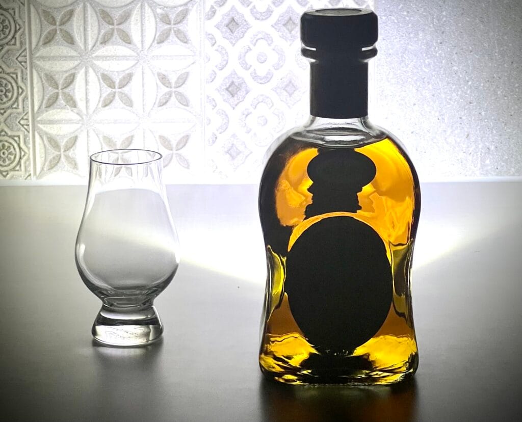 a bottle of whisky next to a glass